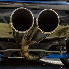 Close up of dual exhaust pipe at the back of car