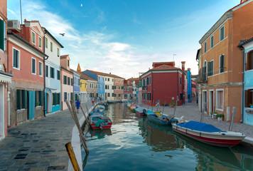 Scenery of canal and colorful vibrant fisherman village in Burano island, Venice, Italy