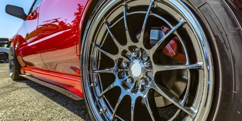 Polished rim of a bright red car
