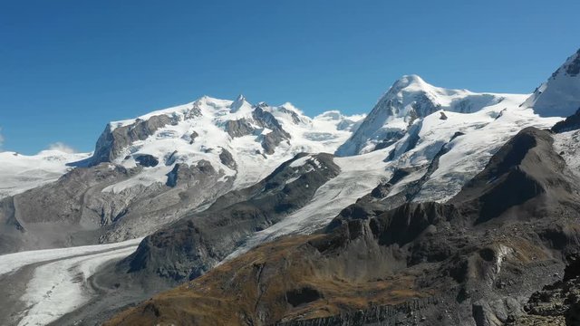 Aerial view of the Monte Rosa Alps with glaciers in Zermatt, Switzerland, backward flight