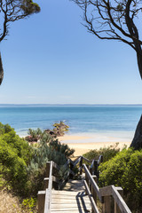 Timber stairs to Red Rocks Beach on a sunny day, Phillip Island, Victoria, Australia