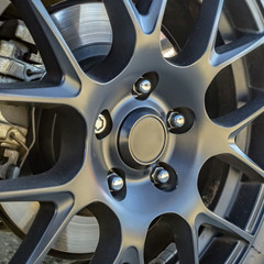 Obraz na płótnie Canvas Tire rim with break pad showing between spokes