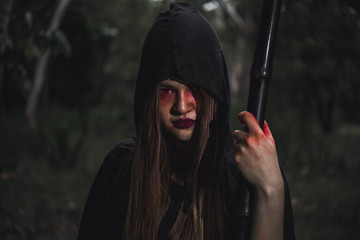 Woman ghost horror her have scythe on hand in forest,