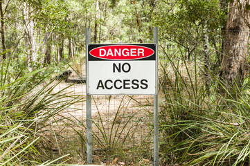 Sign Danger No Access in Australian bushland with wire fence