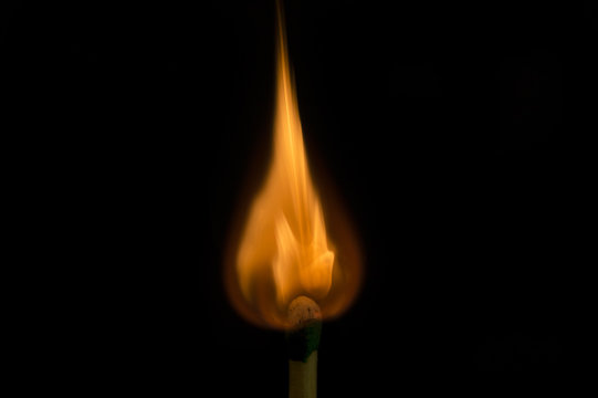 Teardrop shaped flame on tip of match being lit