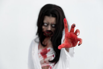 Portrait of asian woman make up ghost face with blood on white background,Horror scene,Scary...