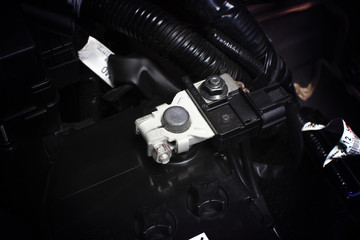 Battery cathode terminal and wire installed on a black battery in a electric system of eco car...