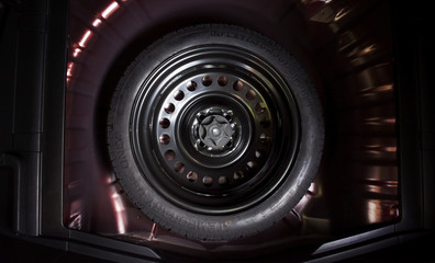 Spare wheel in a car, automotive part concept.