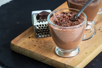 Healthy paleo chocolate yoghurt dessert. Dark background.
