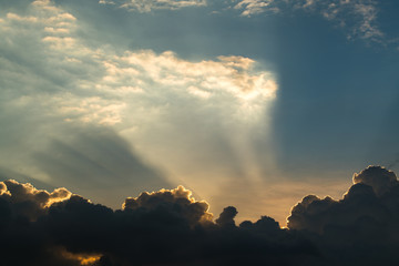 Sun rays through clouds like an dramatic explosion , power nature background.