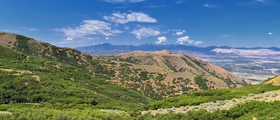 Panoramic Landscape view of Wasatch Front Rocky and Oquirrh Mountains, Rio Tinto Bingham Copper Mine, Great Salt Lake Valley in summer with Cloudscape. Utah, USA.