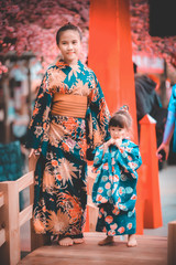 Sisters in japanese traditional kimono with cherry blossom