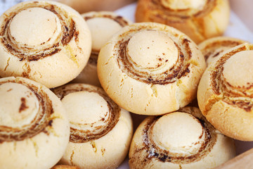 Fresh homemade cookies in form of mushrooms. Round sweet shortbreads. Selective focus.