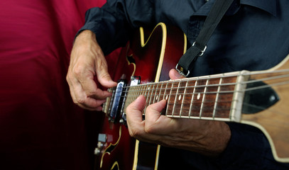 Guitarist hands and guitar close up. playing electric guitar.  - obrazy, fototapety, plakaty
