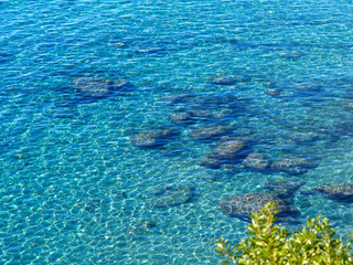 Clear blue sea ocean water over rocks