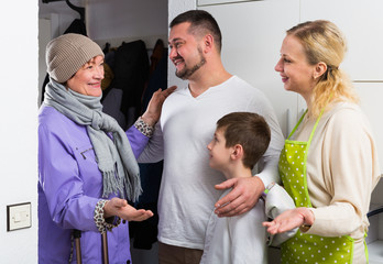 Grandma visiting children and grandson at home