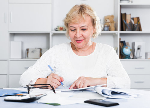 Woman engaged in home accounting
