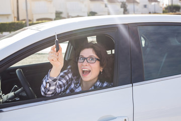 Young Happy Woman Showing The Key Of New Car