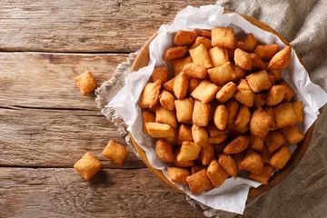 Foto op Canvas Chin chin is a fried snack in West Africa, mostly in Nigeria served in a plate on a close-up. Horizontal top view © FomaA