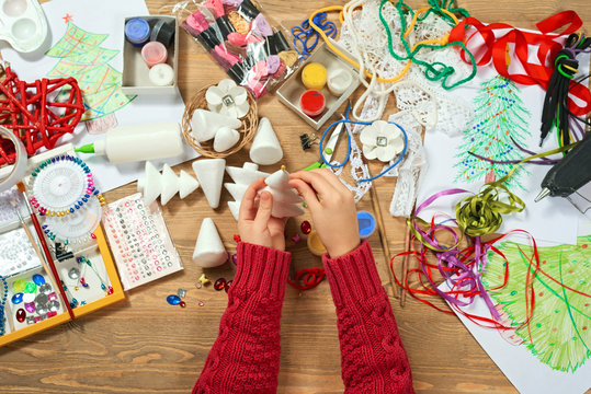 Childrens making decorations for new year holiday. Painting watercolors. Top view. Artwork workplace with creative accessories.