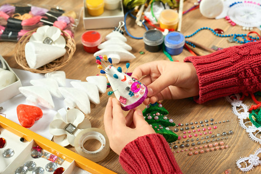 Childrens making decorations for new year holiday. Painting watercolors. Top view. Artwork workplace with creative accessories.