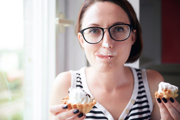 girl eating tasty cakes, sitting by the window, sweet food and pleasure