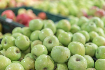 Green apples in a box in the store. green apples in boxes on market shelves. grocery shopping concept. healthy food.