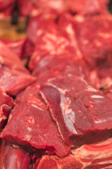 Large piece of red fresh meat on the counter. Tenderloin, steak and ingredients for cooking meat dishes. Meat on the counter in a black box. vertical photo