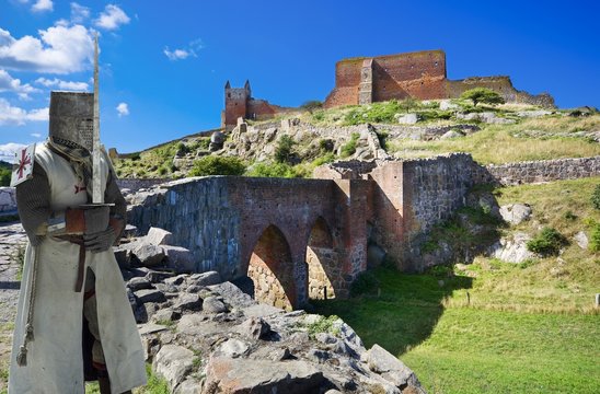 Medieval knight and ruins of Hammershus castle - the biggest Northern Europe castle ruins situated at steep granite cliff on the Baltic Sea coast, Bornholm, Denmark