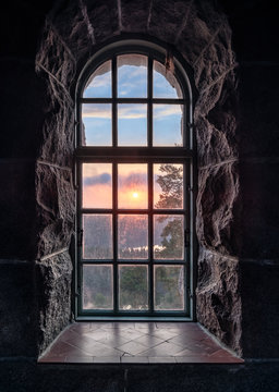 Fototapeta Cosy view looking through an old window with sunset at autumn morning in National Park, Finland