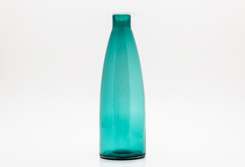 Empty turquoise glass bottle isolated on a white background with a clipping path.