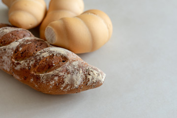 Bread and whole grain bread on light textured background