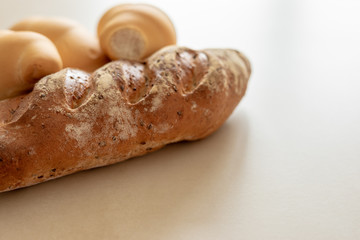 Bread and whole grain bread on light textured background