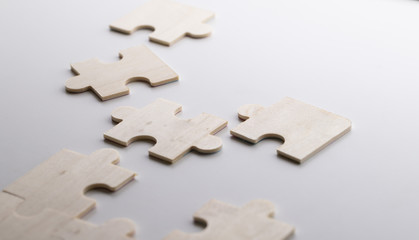 Incomplete puzzles on wooden white table