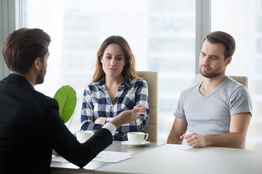Unhappy couple dislike house offer from realtor or architect, boyfriend and girlfriend buying first home together dissatisfied with option prepared by broker, man and woman bored at meeting with agent