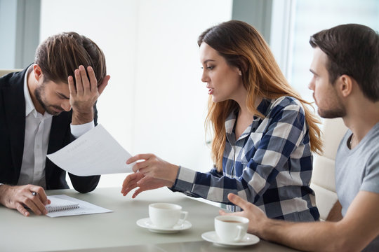 Dissatisfied wife have dispute with realtor or broker in office discussing contract mistakes or terms, consultant feel annoyed or bothered by angry woman proving document incorrect at meeting