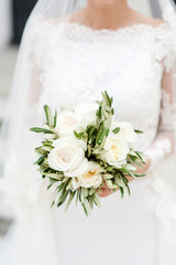 Beautiful bouquet from white flowers  in the bride's hands