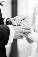 Hands of the happy groom and the bride at a wedding ceremony