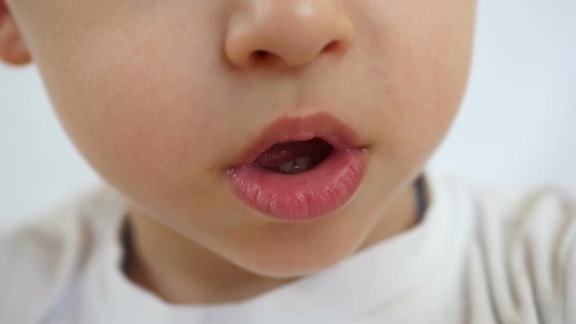 Close-up: the child's mouth opens and closes.