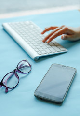 hand of business working at home or office on blue table