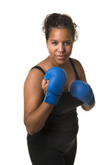 Naklejka premium Young pretty black woman with boxing gloves isolated on a white background in a vertical image