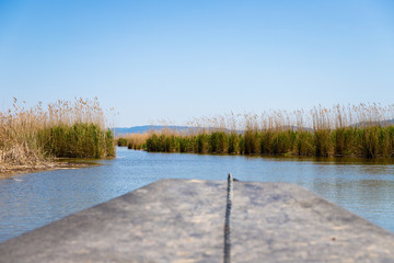 View of the stubble fields while crossing the river on a wooden boat