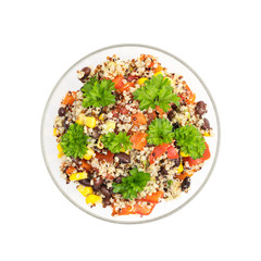 Glass bowl with quinoa salad with red pepper, corn, tomato and black beans, topped with parsley seen directly from above and isolated on white background