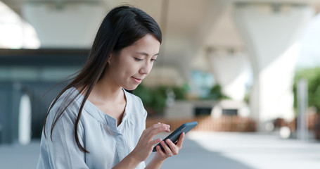 Woman use of mobile phone in city