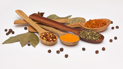 Spice. Spice in a wooden spoon. Herbs. Curry, saffron, turmeric, pepper and other isolated on white background.