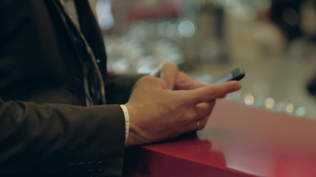 Close-up businessman using smartphone. Technology concept.