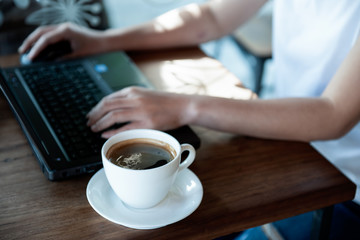 Office girl hand on laptop keyboard and mouse.