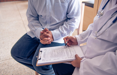 The doctor is discussing with the patient after a physical examination of the results and treatment guidelines.
