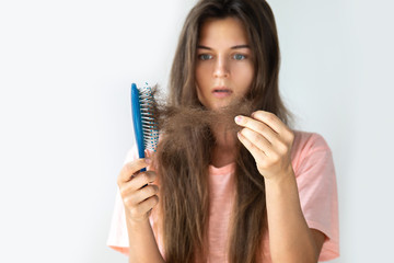 Young woman is upset because of hair loss