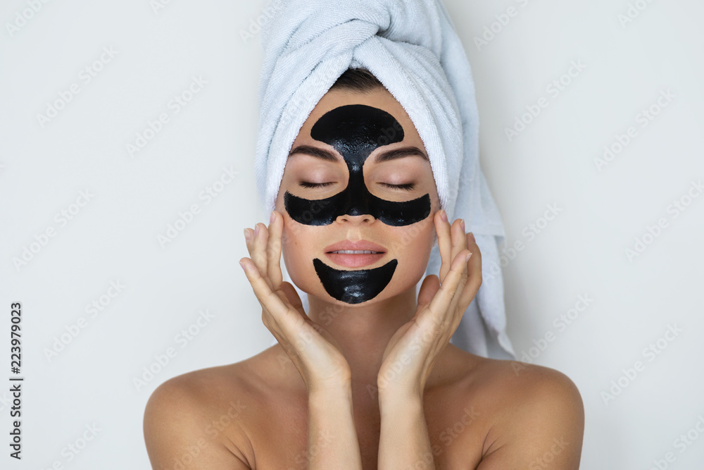 Canvas Prints Young and beautiful woman with black peel-off mask on her face